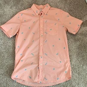 Short sleeve button down. Colors are pink with blue tiki theme images